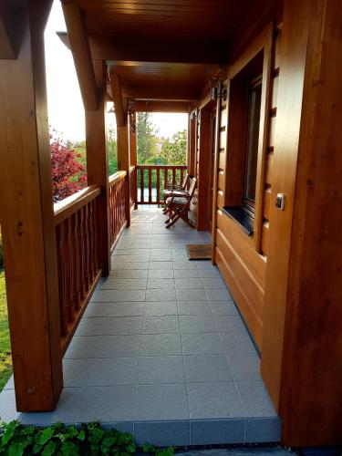 a porch of a house with a wooden ceiling at Chalupa u Macochy in Blansko