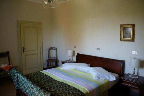a bedroom with a bed with a wooden head board at Tenuta Terensano in Monleale