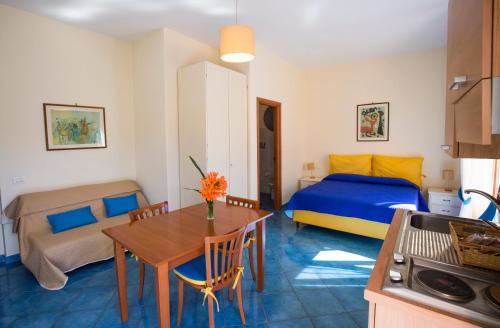 a living room with a bed and a table in a room at Villa Rosa Sorrento in Sorrento