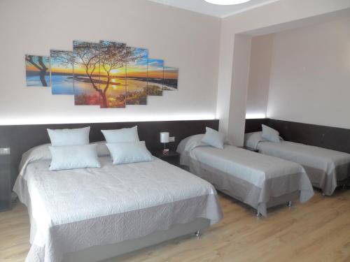 a bedroom with two beds and a painting on the wall at BELLAVISTA B&b in Lamezia Terme