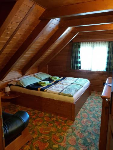 a bedroom with a bed in a attic at Chalupa u Macochy in Blansko