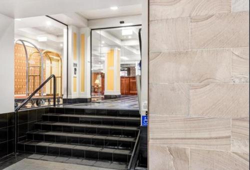 a staircase in a building with a glass door at S&P Apartments - Central Station in Brisbane