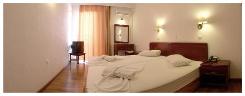 コス・タウンにあるSanta Marina Hotel Apartmentsのベッド2台とテレビが備わるホテルルームです。