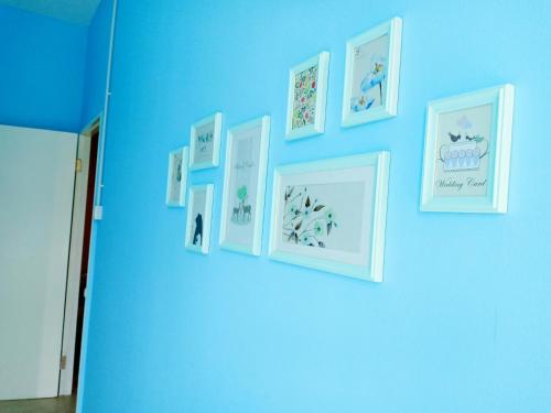 a blue wall with pictures on a blue wall at CJ Home-ex Micasa shoplot in Sibu