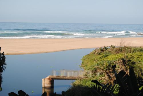 a view of a beach with a pier and the ocean at 5 Key Largo in Amanzimtoti