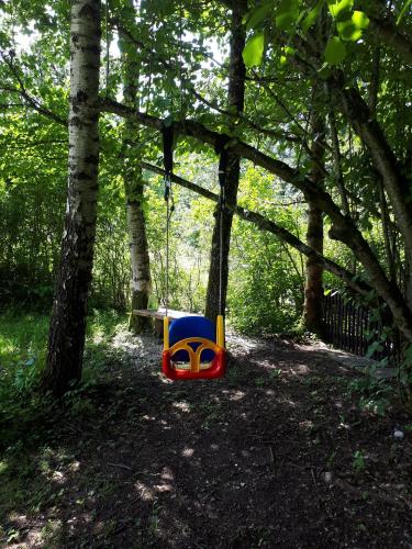 a toy swing in the woods with a table at Lucky Lady in Spital am Pyhrn