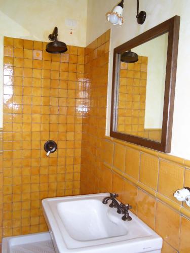 a bathroom with a sink and a mirror at Agrituirsmo Masseria Campierti in Falciano del Massico