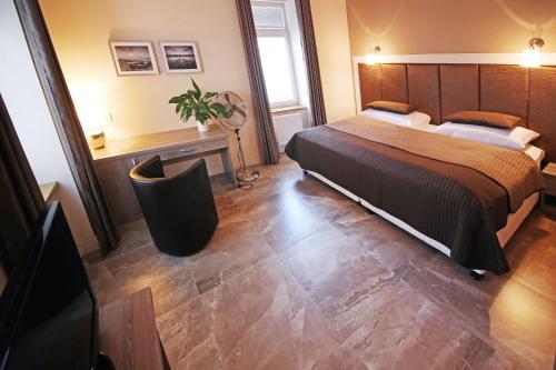 a bedroom with a large bed in a room at Penzion a Restaurace Stará Roudná in Plzeň