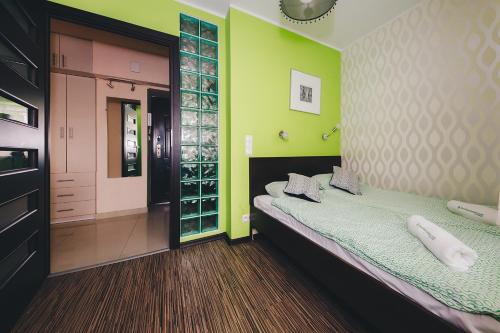 ワルシャワにあるShortStayPoland Solidarnosci (B8)の緑の壁のベッドルーム1室(ベッド1台付)、