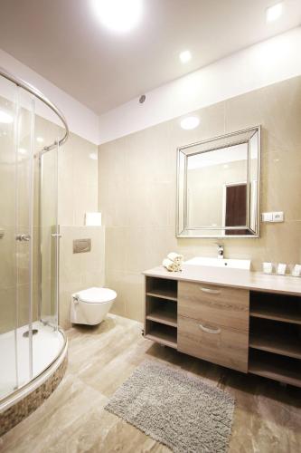 a bathroom with a tub and a sink and a toilet at Penzion a Restaurace Stará Roudná in Plzeň