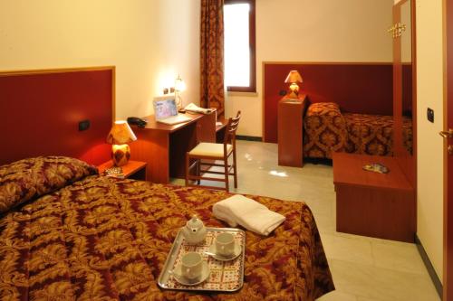 a hotel room with a bed and a desk at Hotel HDomus in Nogarole Rocca