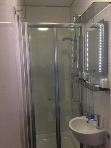 a bathroom with a shower and a sink at Lochalsh View en suite Kyle near Skye in Kyle of Lochalsh