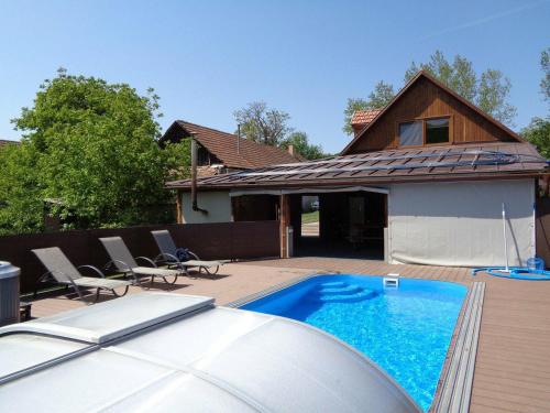 a swimming pool in front of a house at Gyöngyszemvendégház in Sátoraljaújhely