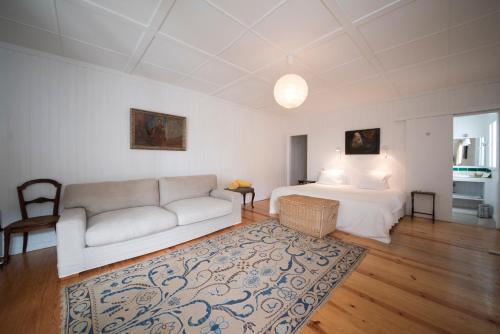 a living room with a bed and a couch at Casal do Frade in Sesimbra