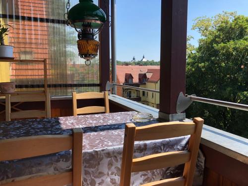a table and chairs on a balcony with a window at Schlossblick Apartment in Gotha