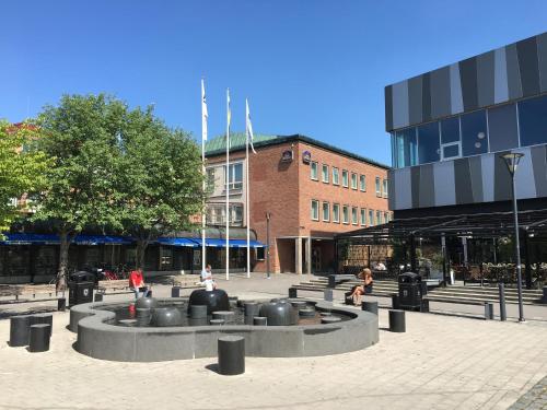a fountain in a courtyard in front of a building at Best Western Hotel Akersberga in Åkersberga