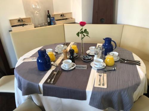 a table with blue vases and utensils on it at Hotel Friedrich in Hachenburg