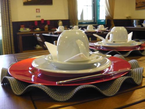 a table with plates and hats on top of it at Casa do Colegio Velho in Vila Viçosa