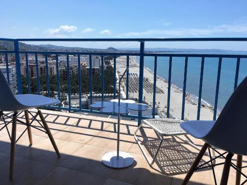 a balcony with chairs and a view of the beach at Beachfront Marilyn in Durrës
