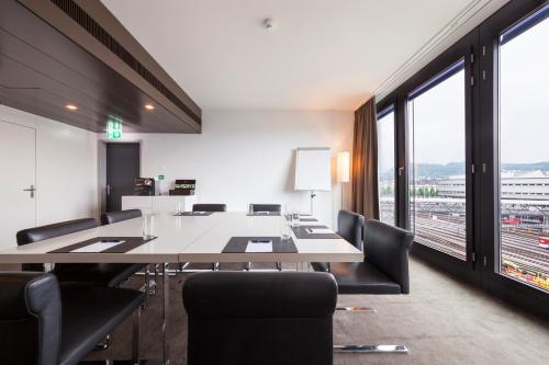 a conference room with a large table and chairs at Radisson Blu Hotel, Lucerne in Luzern