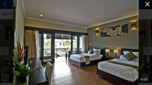 a hotel room with two beds and a couch at Legian Family villa with pool in Legian