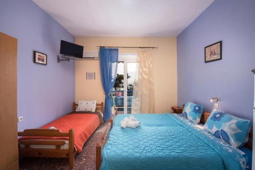 a bedroom with a bed and a bed and a window at House Souzanna in Toroni