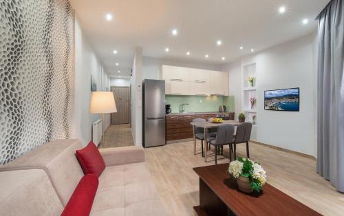 a living room and kitchen with a couch and a table at Kamis Suite in Neos Marmaras