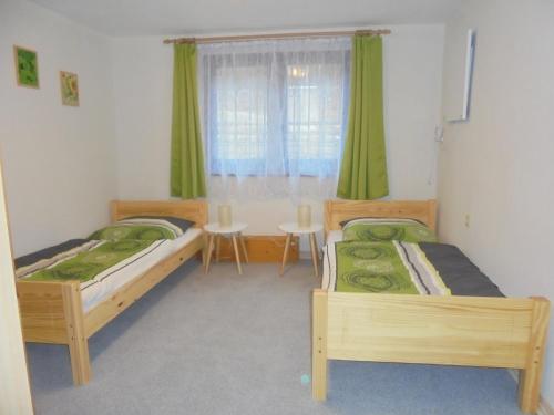 a bedroom with two beds and a table and a window at Bergfreiheit in Schierke