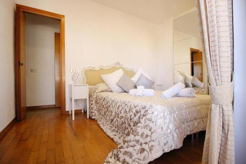 a bedroom with a large bed with white pillows at Apartament Monte Mario in Rome