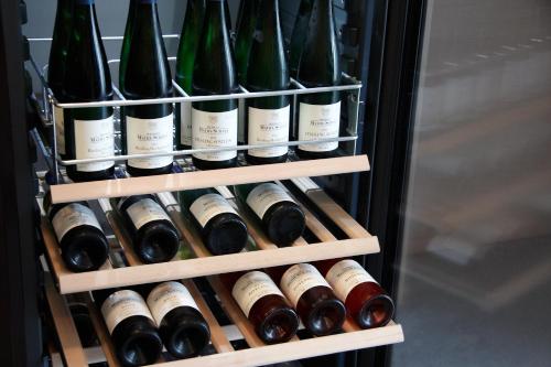 a refrigerator filled with lots of bottles of wine at Gästehaus Weingut Mathy-Schanz in Osann-Monzel
