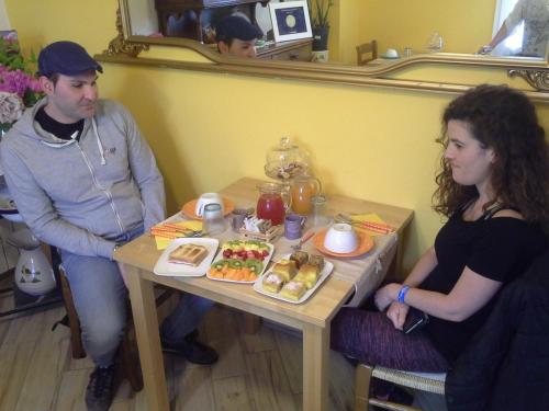 a man and a woman sitting at a table with food at B&B Ciccilia in Bentivoglio