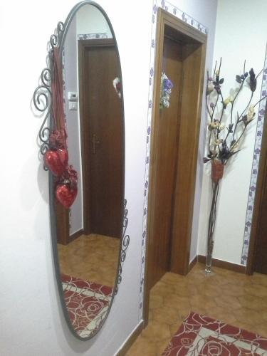 a mirror hanging on a wall in a hallway at B&B Ciccilia in Bentivoglio