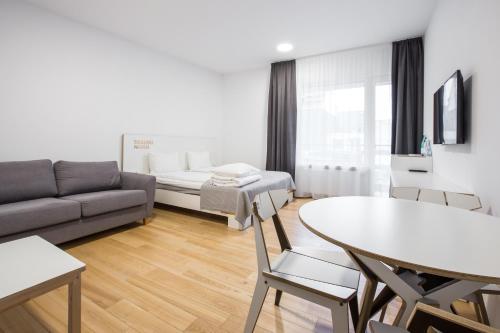 a living room with a couch and a table at #draugunamai in Druskininkai