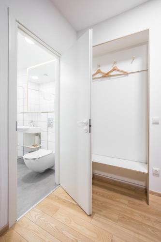 an open door to a bathroom with a toilet and a sink at #draugunamai in Druskininkai
