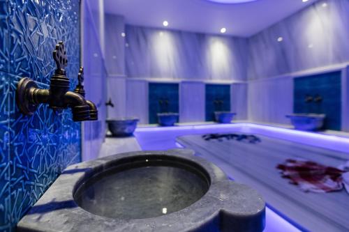 a bathroom with a sink and a bath tub at Mari Suites Hotel in Istanbul