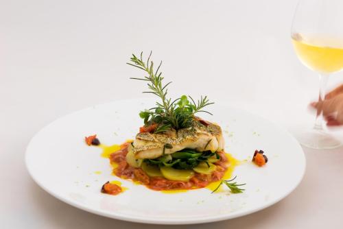 a plate of food with a piece of fish on top at Aquila Porto Rethymno in Rethymno Town