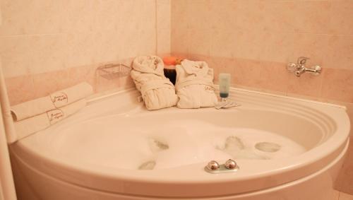 a bath tub with towels sitting on top of it at Residence Le Magnolie in Forlì