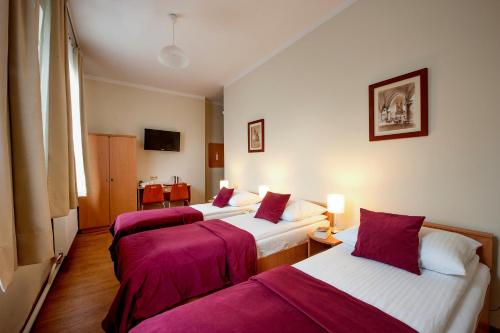 Cama o camas de una habitación en Mały Kraków Aparthotel