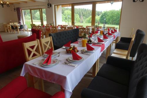 a long table with plates and napkins on it at Willa Zaolzie in Istebna