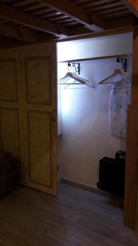 a room with a closet with hangers and a door at l'arco di Sersa in Riccò del Golfo di Spezia
