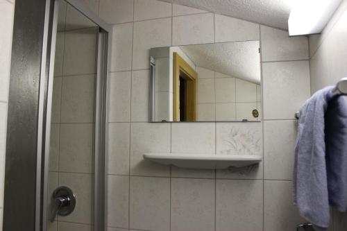 a bathroom with a sink and a mirror at Haus am Mühlanger in Serfaus