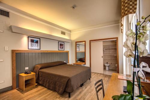 - une chambre avec un lit et une table dans l'établissement Hotel Delle Nazioni, à Florence