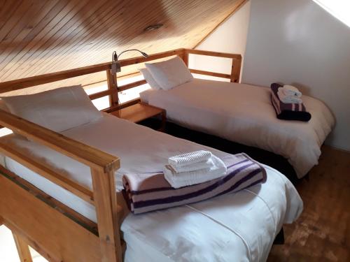 a small room with two beds at Kozmos in Clarens