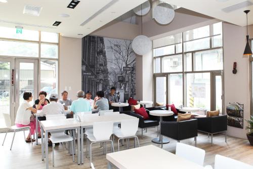 a group of people sitting at tables in a restaurant at Micasa Hotel in Taichung
