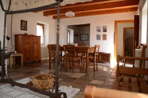 a kitchen and dining room with a table and chairs at A casa mia in Meduno