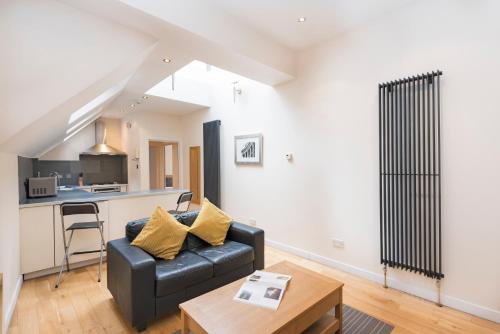 a living room with a couch and a table at St Paul's by Excel Apartments in London