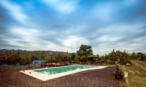 a swimming pool in the middle of a yard at Complejo Flores Azules in Olta