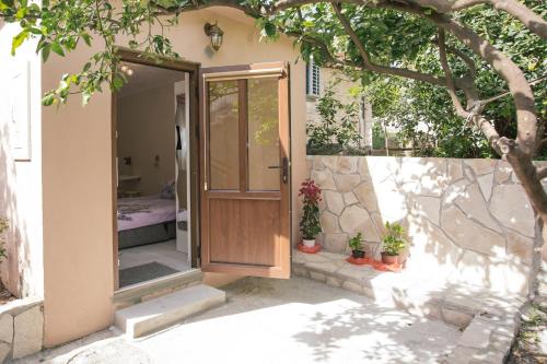 an open door of a house with a bedroom at Studio Jeff 1 in Kotor