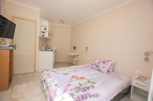a small bedroom with a bed and a kitchen at Studio Jeff 1 in Kotor