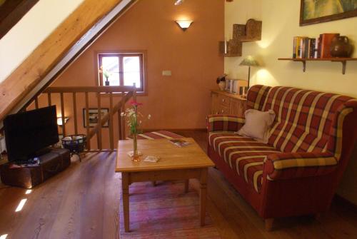 uma sala de estar com um sofá e uma mesa em Ferienwohnung im Schuhhof em Quedlinburg